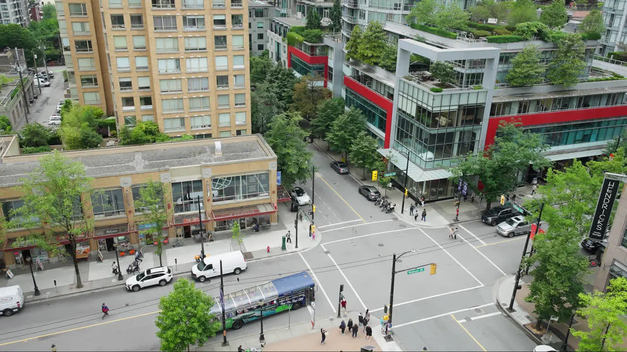 Urban Street Intersection in Vancouver City Downtown District Cars and and Pedestrians Going About Their Day