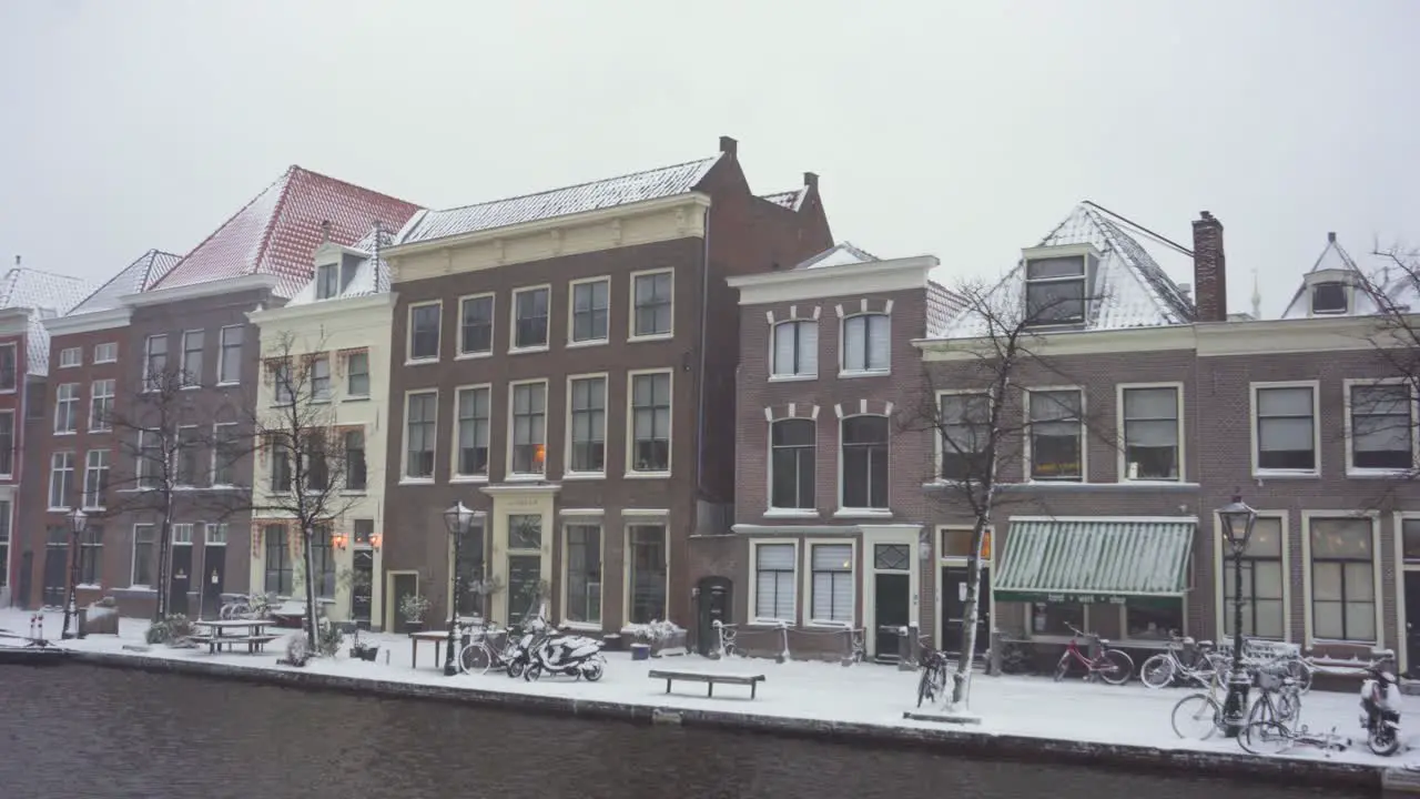 Leiden city buildings in winter snow on Rijn riverside Netherlands panoramic