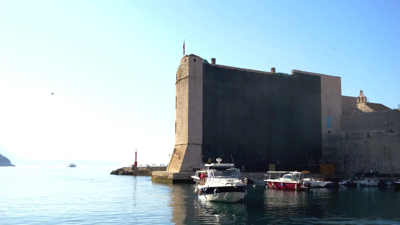 Dubrovnik yachts anchored in the harbor with the fortress walls in the background