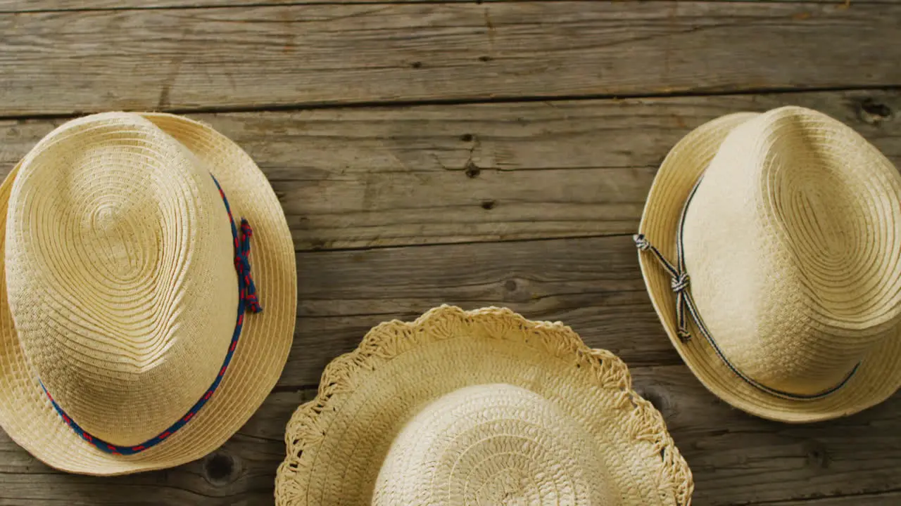 Video of close up of hats on wooden background