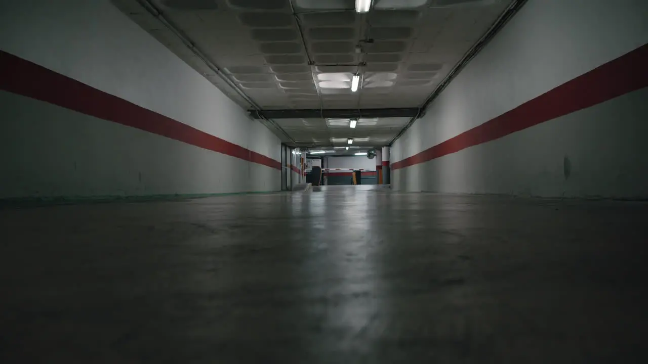 Empty underground driveway with dim flickering light