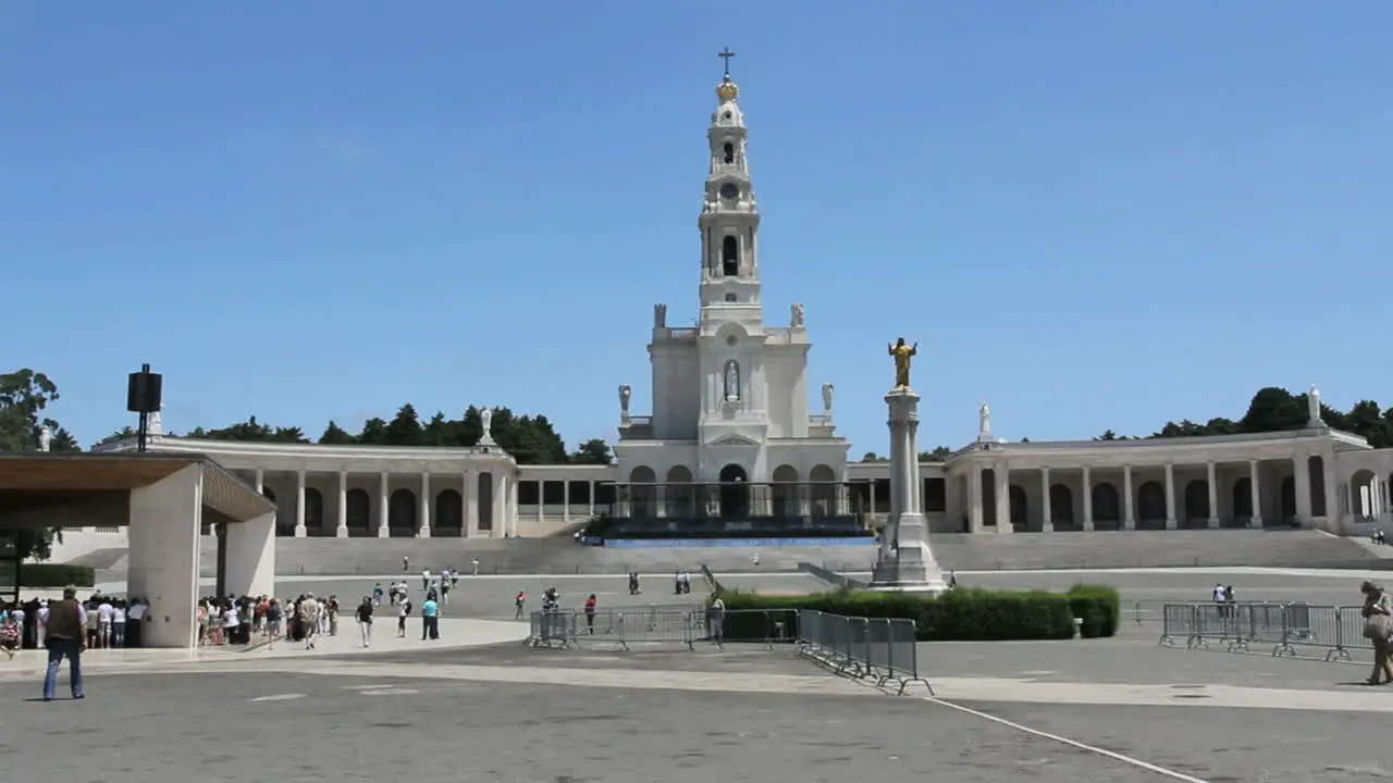 Fatima church with statue and pilgrims