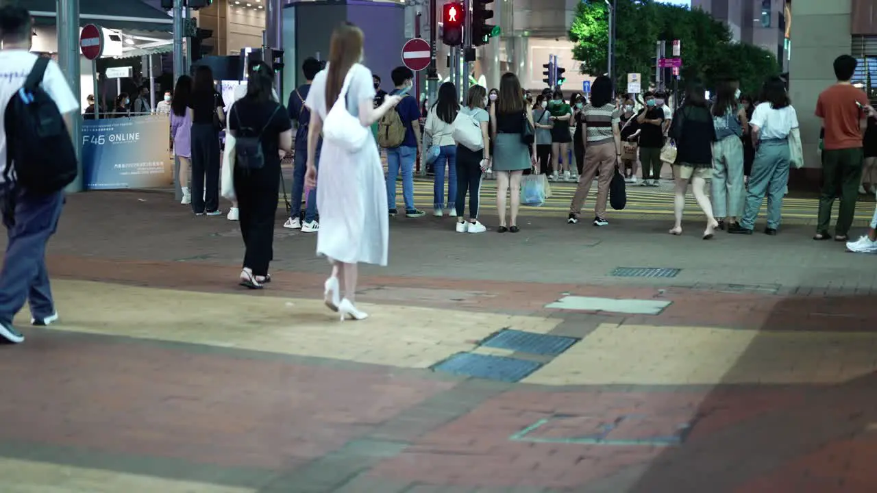 People waiting for the light signal to walk on one of the Hongkong streets