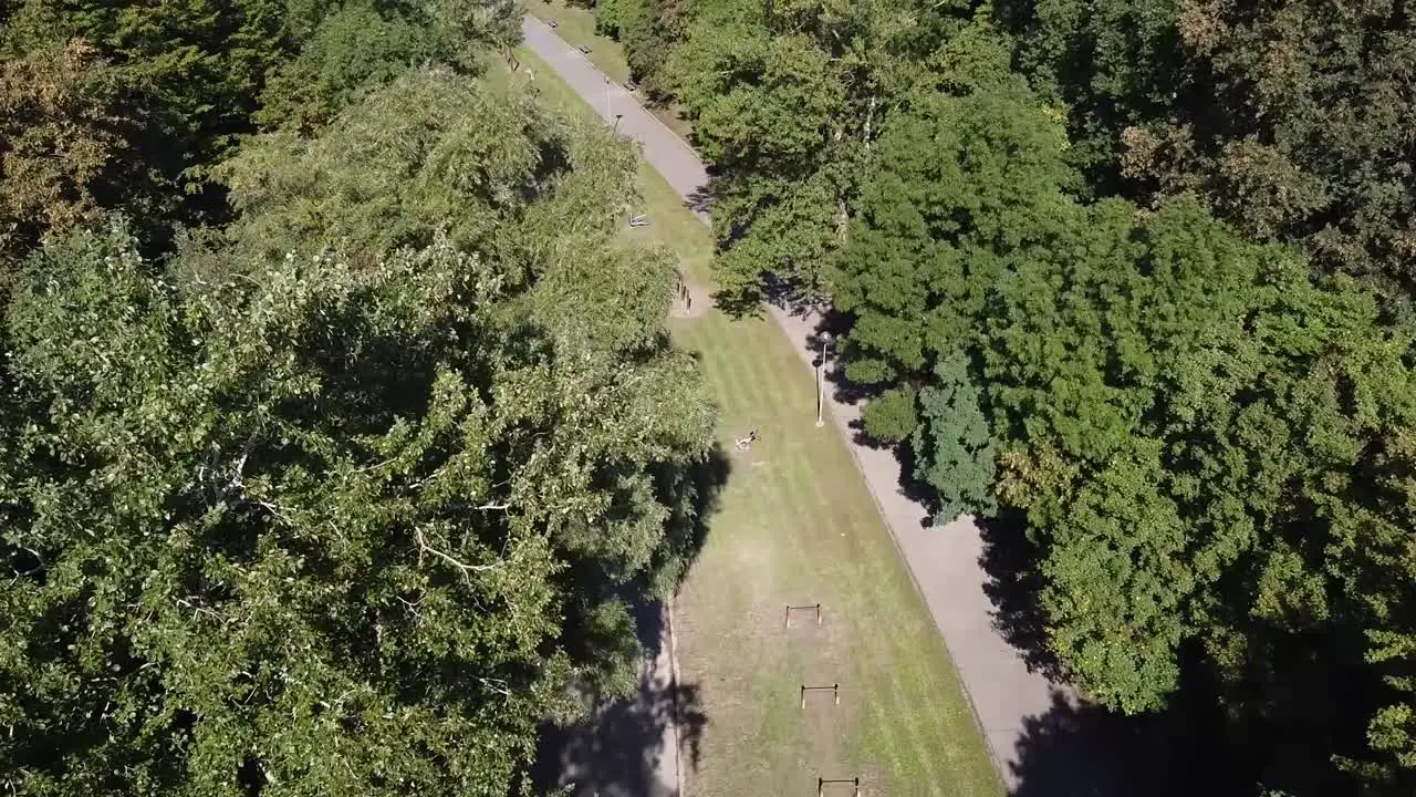 travel drone shot european green public park with excercise tools entrance empty