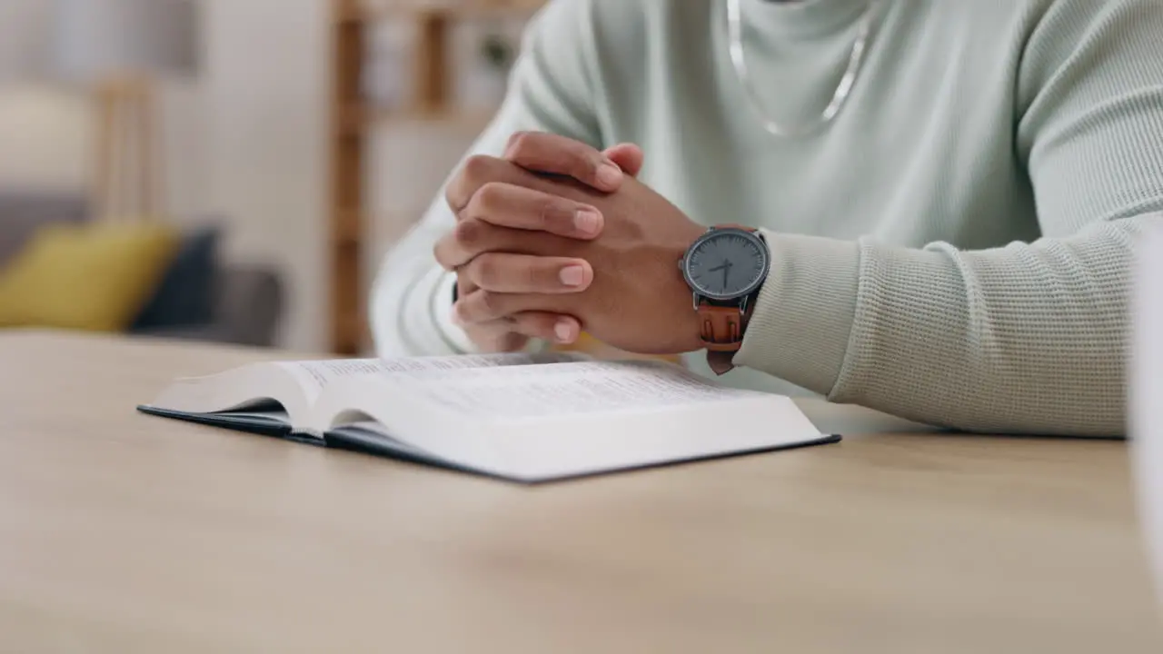 Closeup bible and hands with man praying