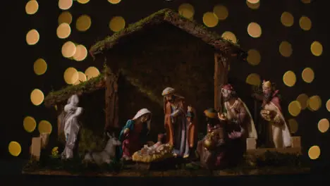 Studio Christmas Concept Of Baby Jesus In Manger With Figures From Nativity Scene With Lights 5