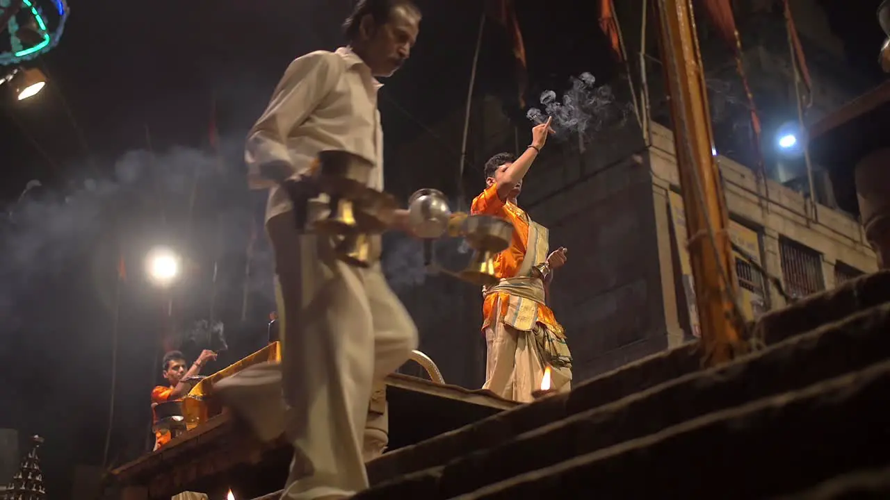 Man Waves Incense and Rings Bell at Night