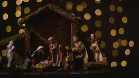 Studio Christmas Concept Of Baby Jesus In Manger With Figures From Nativity Scene With Lights 4