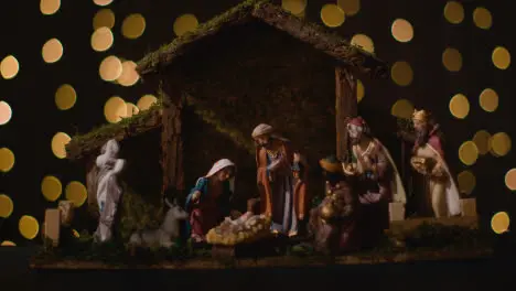 Studio Christmas Concept Of Baby Jesus In Manger With Figures From Nativity Scene With Lights 3