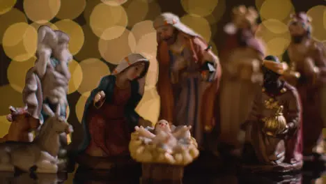 Studio Christmas Concept Of Baby Jesus In Manger With Figures From Nativity Scene With Lights 