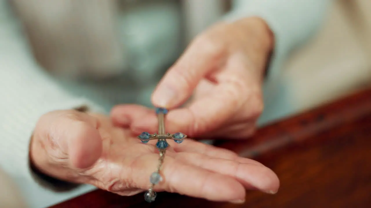 Rosary praying or hands of woman in church