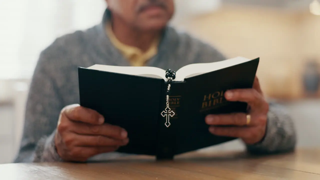 Hands reading and bible study for man in home