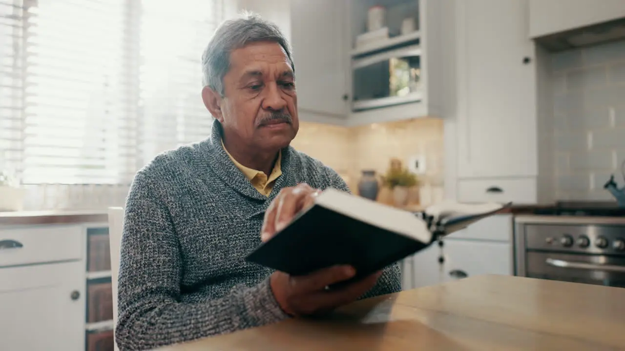 Senior man reading and bible study in home