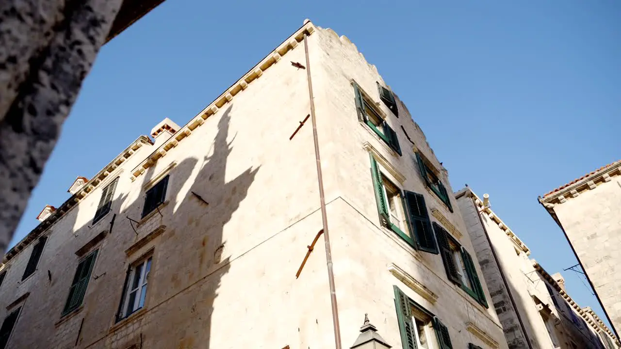 Dubrovnik atmospheric alley and buildings with shutters in the light of the morning sun