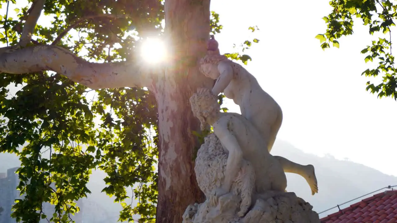 Dubrovnik a sculpture standing in front of the entrance illuminated by the rays of the morning sun