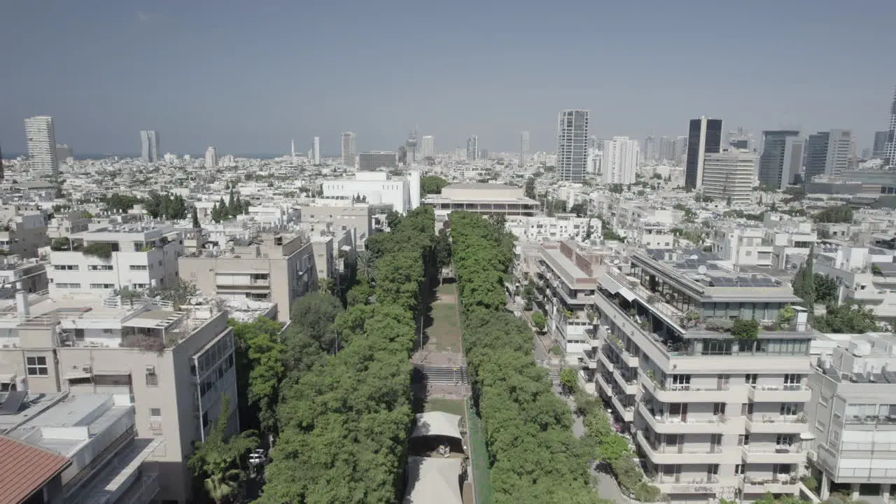 Flying above the trees of Rothschild blvd to Habima Theater new building In Tel Aviv and Menashe Kadishman statue it's a social and dating meeting place