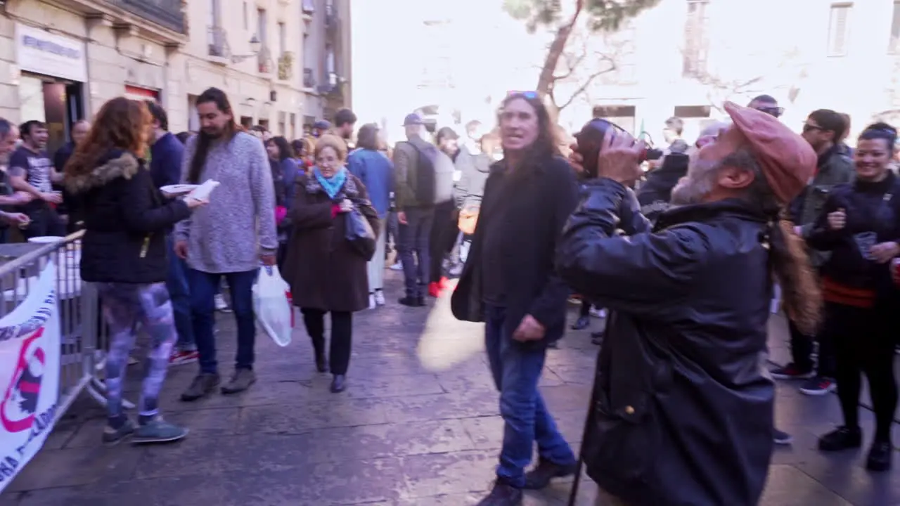 People at BBQ Festival Drinking Wine from Canteen in Barcelona Spain