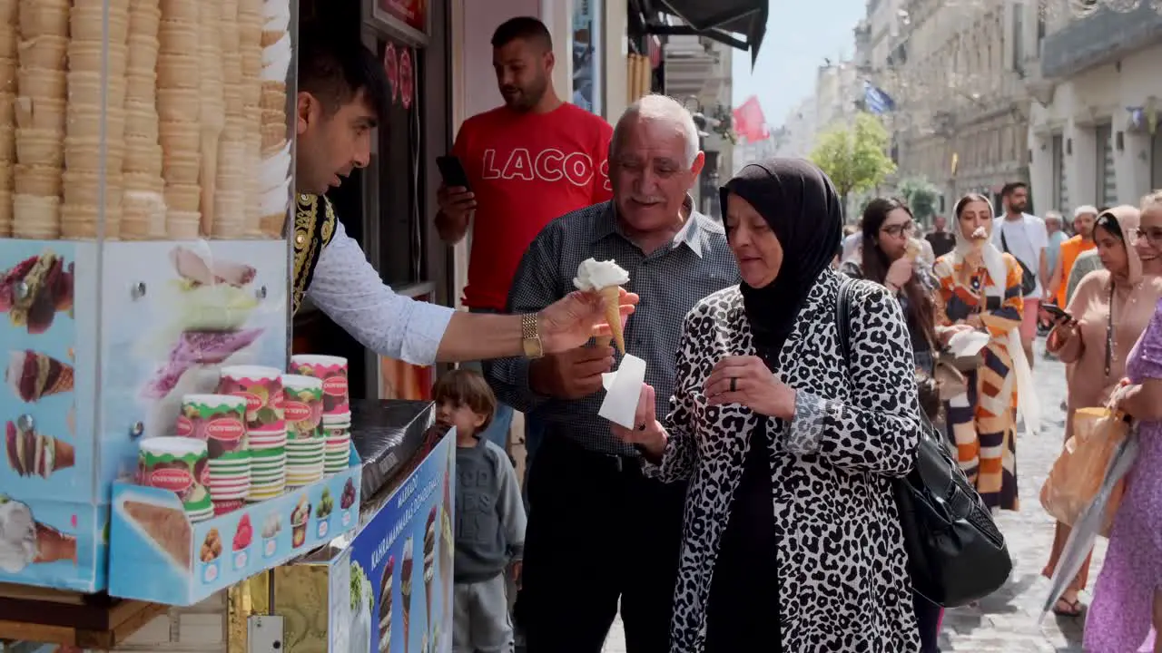 The footage shows the interaction of the ice cream man with an older Muslim couple in Taksim street who are laughing and enjoying the ice cream man's performance