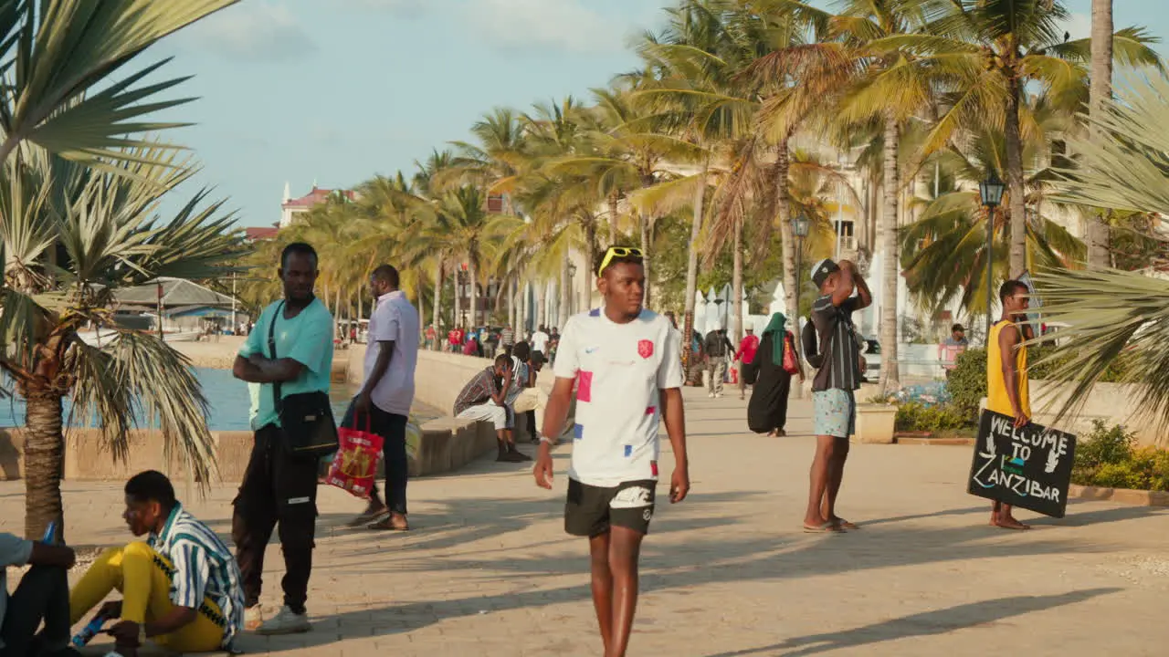 Locals walking along the Stone Town promenade