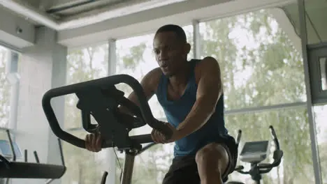 Close-up view of caucasian female monitor and an athletic african american man in the gym