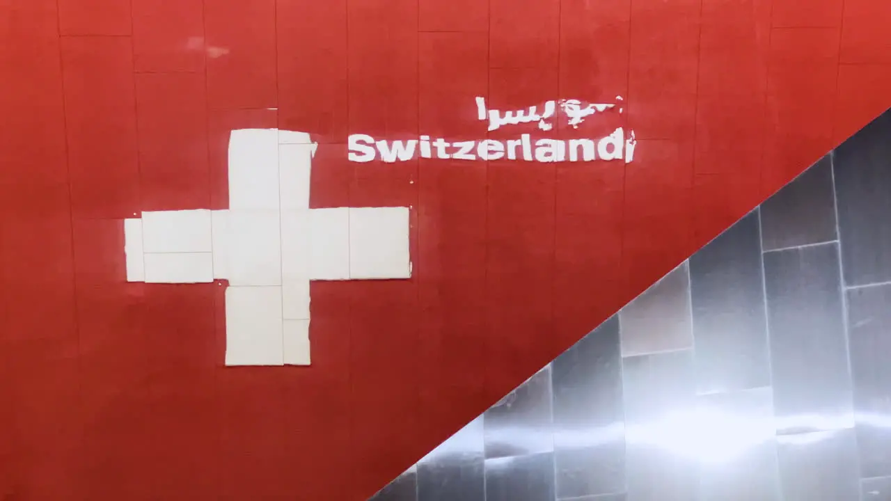 Switzerland pavilion logo and flag seen in a reflection at EXPO Dubai 2020