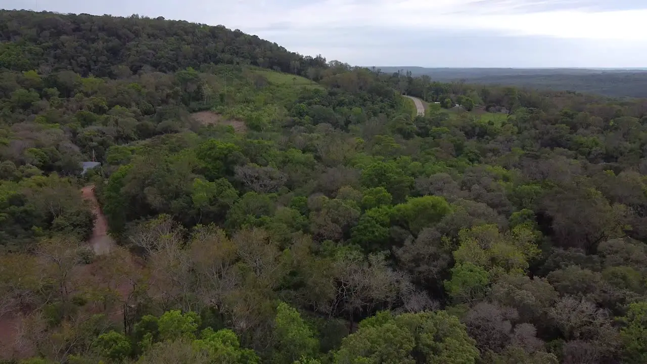 Drone shot Argentina Santa Ana House and Road in the Forest with midday afternoon blue sky cloudy landscape around Santa Ana