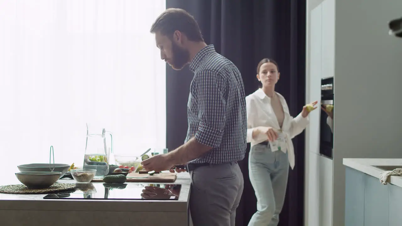 Couple Preparing Food In A Modern Style Kitchen