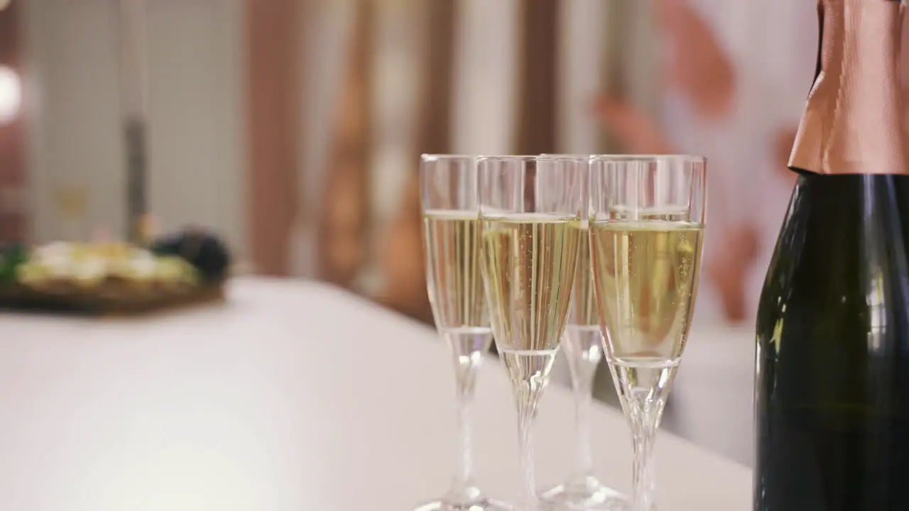 Side View Of A Champagne Bottle And Crystal Glasses With Champagne On A Table At A Bachelorette Party