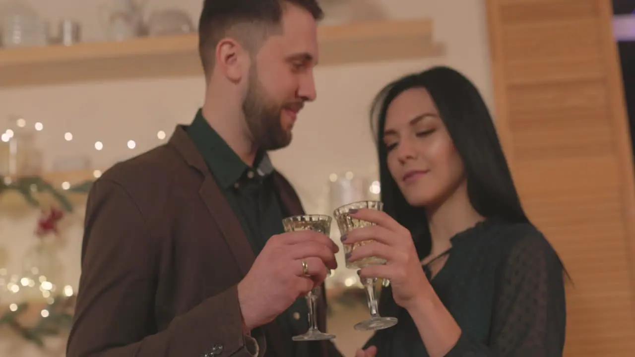 Loving Couple Toasting And Looking To Each Other At Home On Christmas