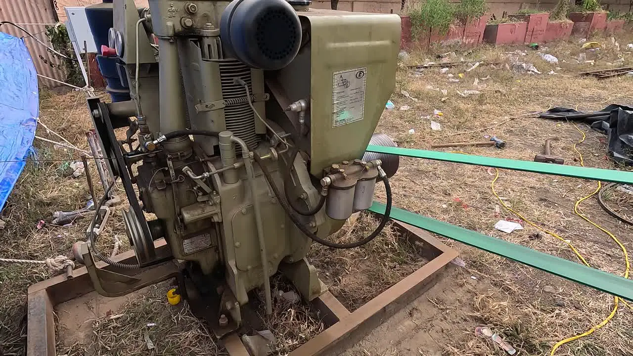 A very old diesel engine which is still in running condition and can be seen running