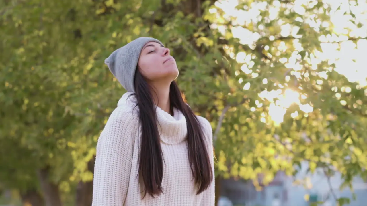 Relaxed Woman Breathing Fresh Air Standing In The Park In Autumn