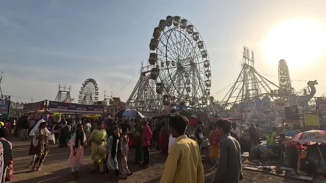 During the day people are visiting the amusement park with their families and enjoying the ride