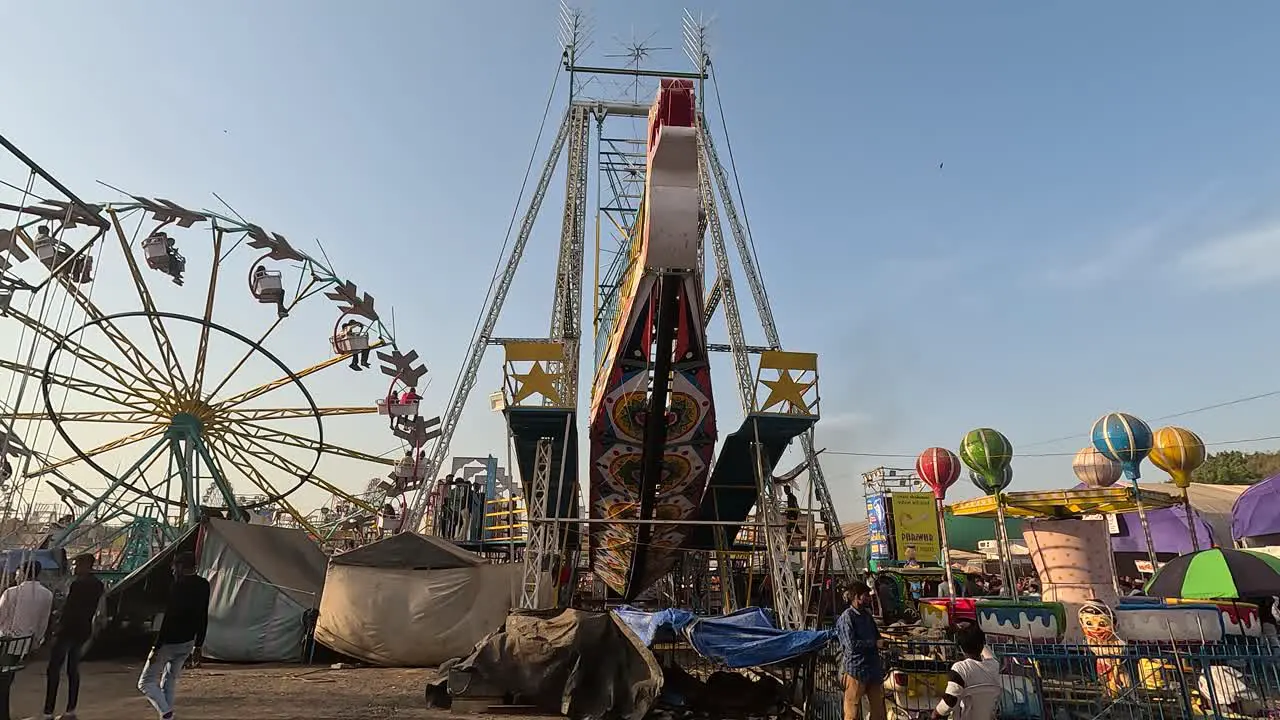 Ground shot an amusement park ride touching space with people enjoying it