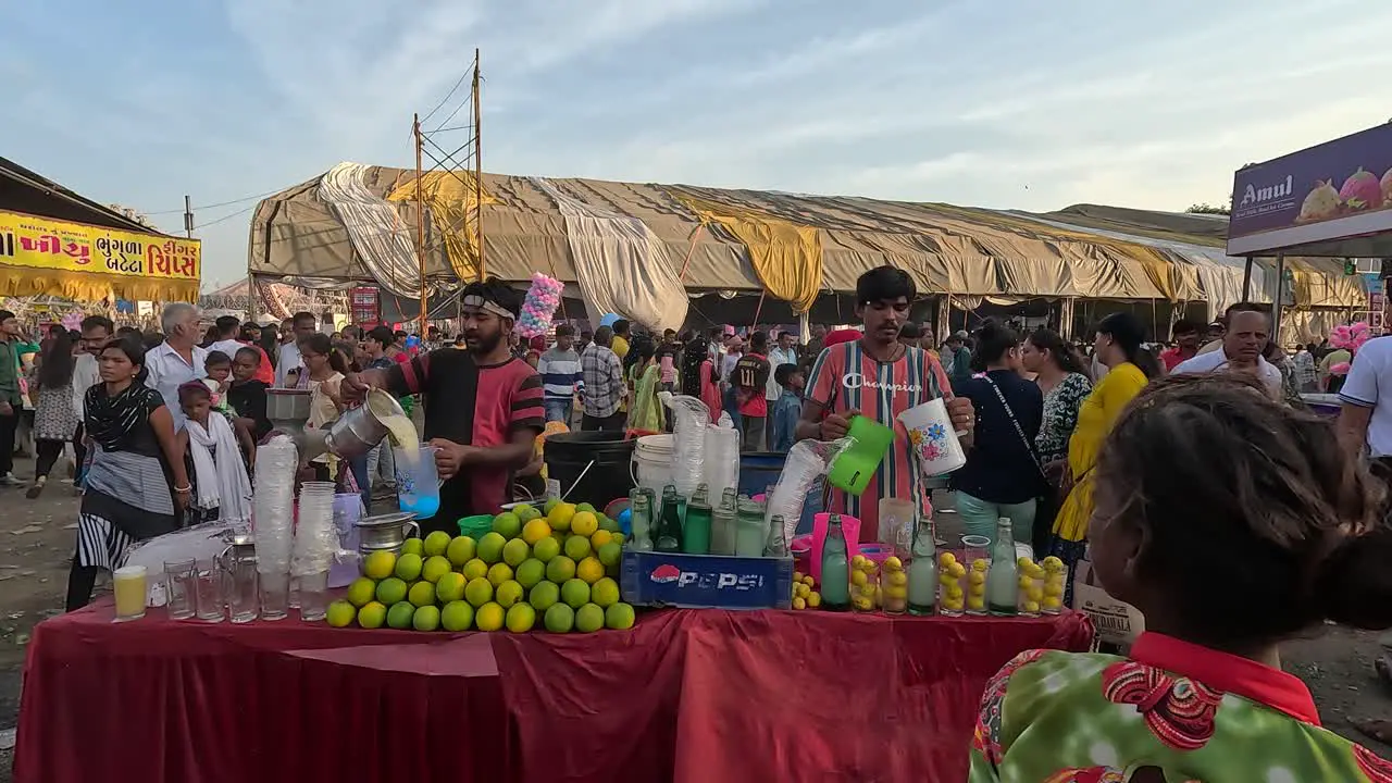 Two shopkeepers are making spicy lemonade at the fair