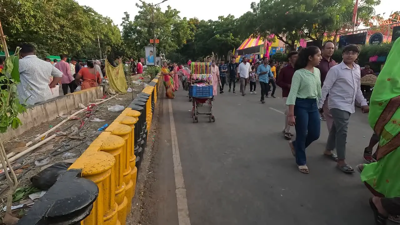 A street road scene outside an amusement park with people walking into the park