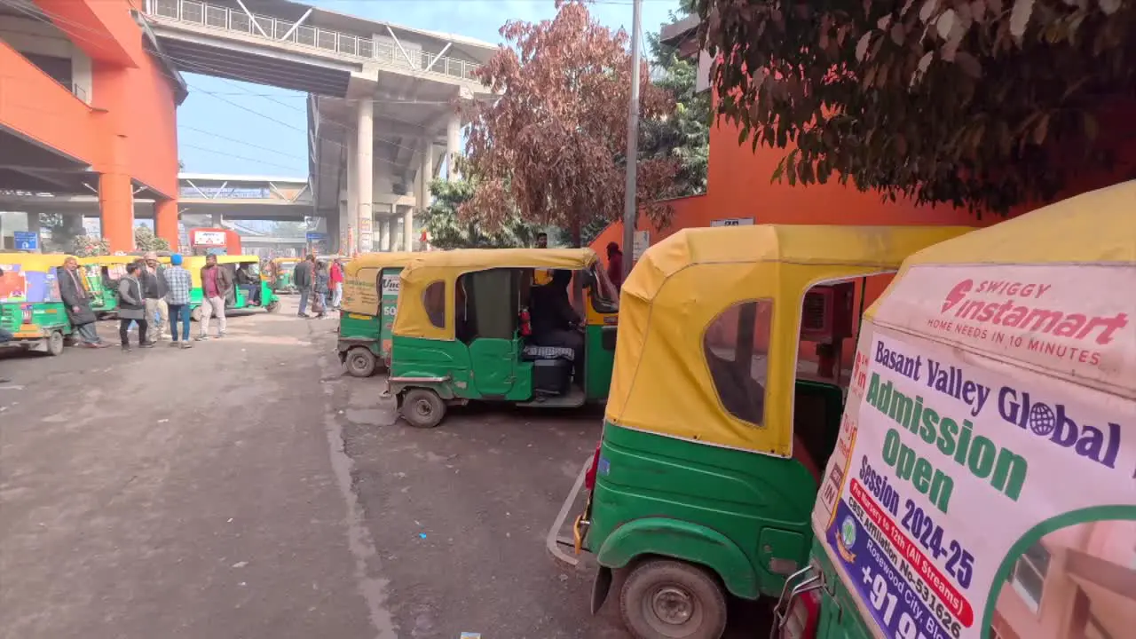 A bunch of autorickshaws outside Sikanderpur metro station