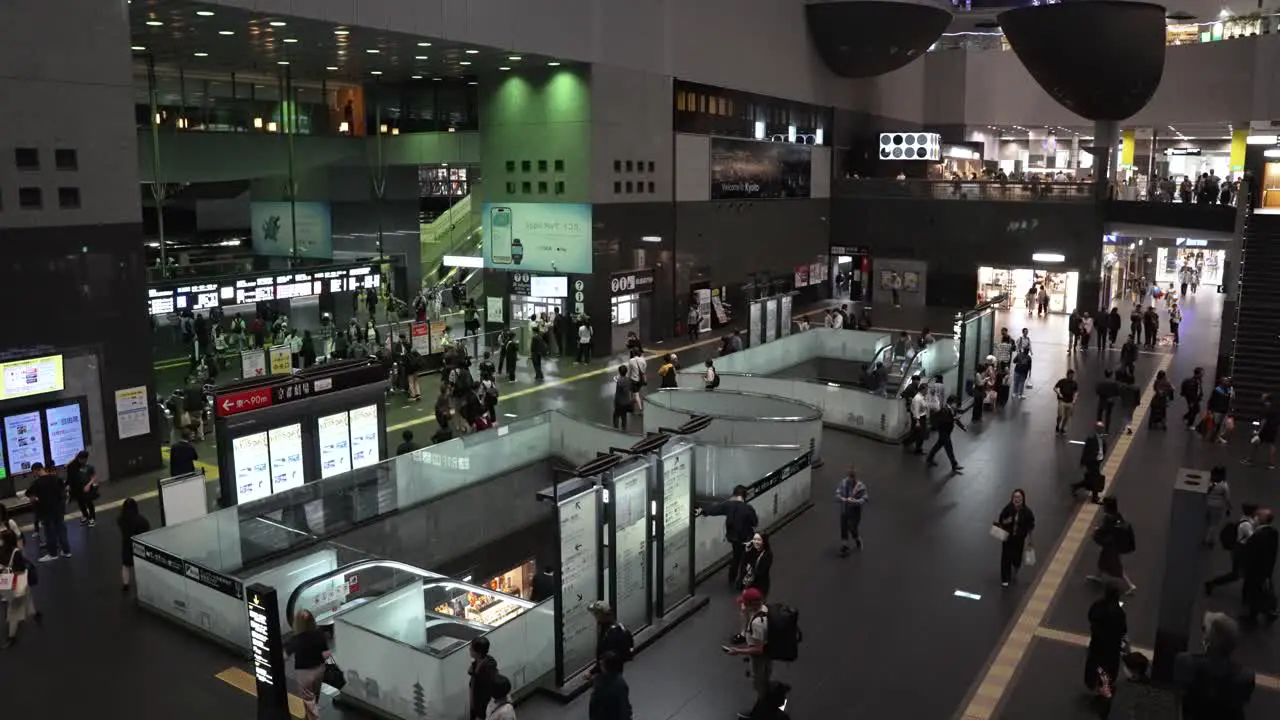 People walking through the Kyoto station at night