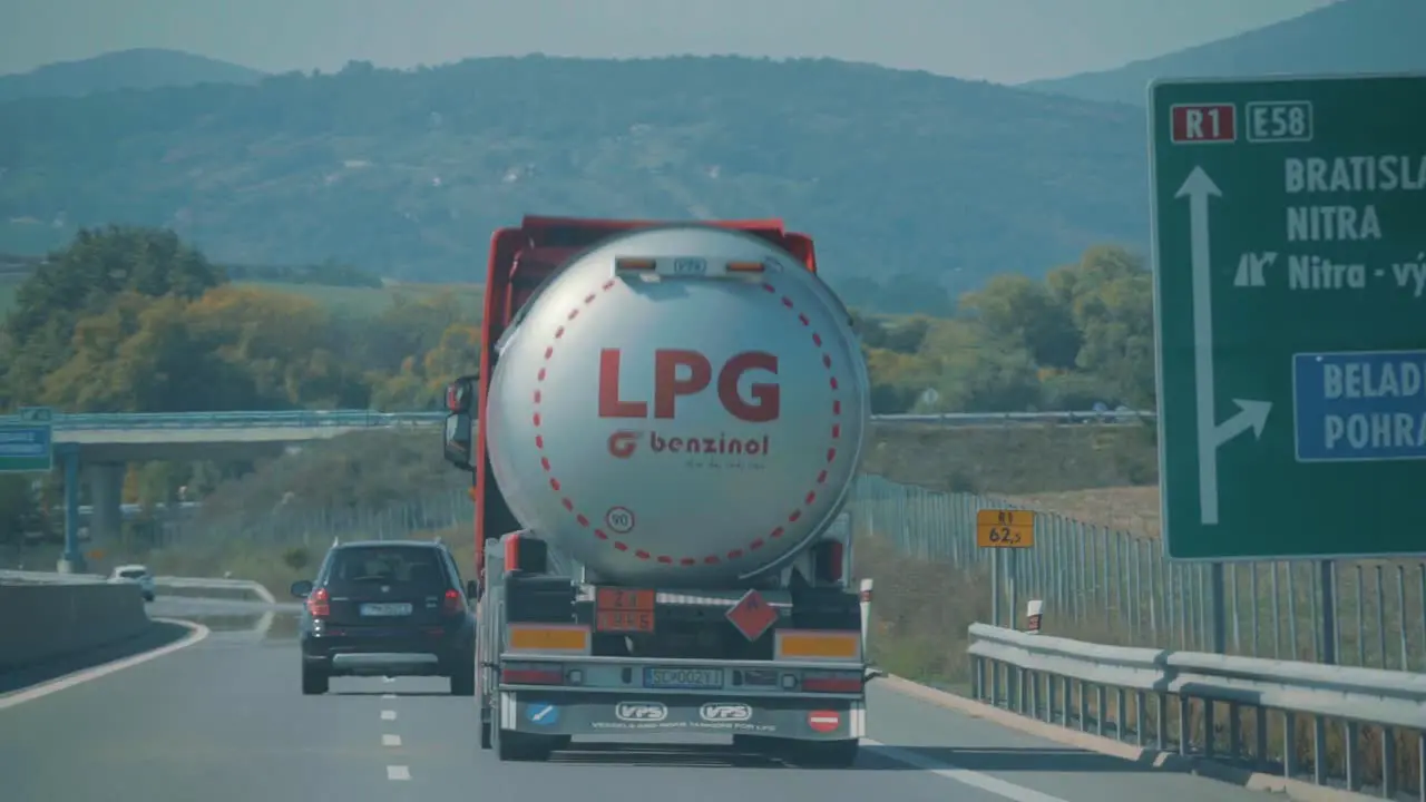 Following A Gasoline Tanker Trailer Truck Driving On A hot Highway In Bratislava Slovakia handheld POV summer