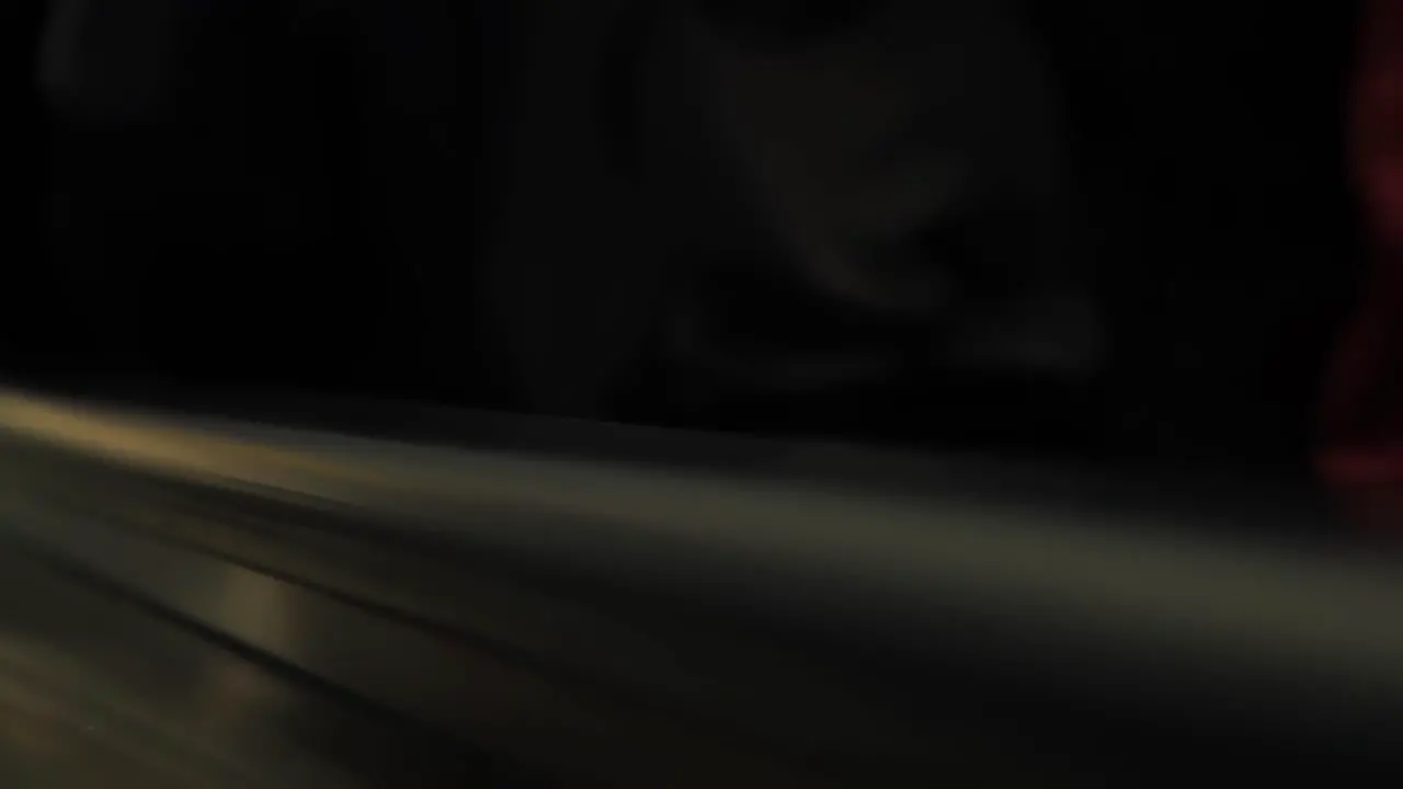 Close up of hands of crowd holding a black handrail at public transport escalator