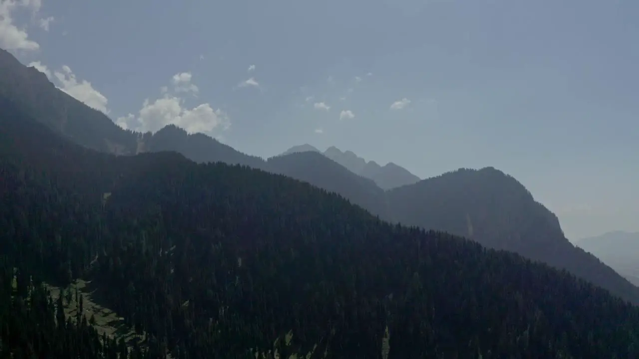 aerial drone view The drone camera is going to the upper side where the big mountains are visible