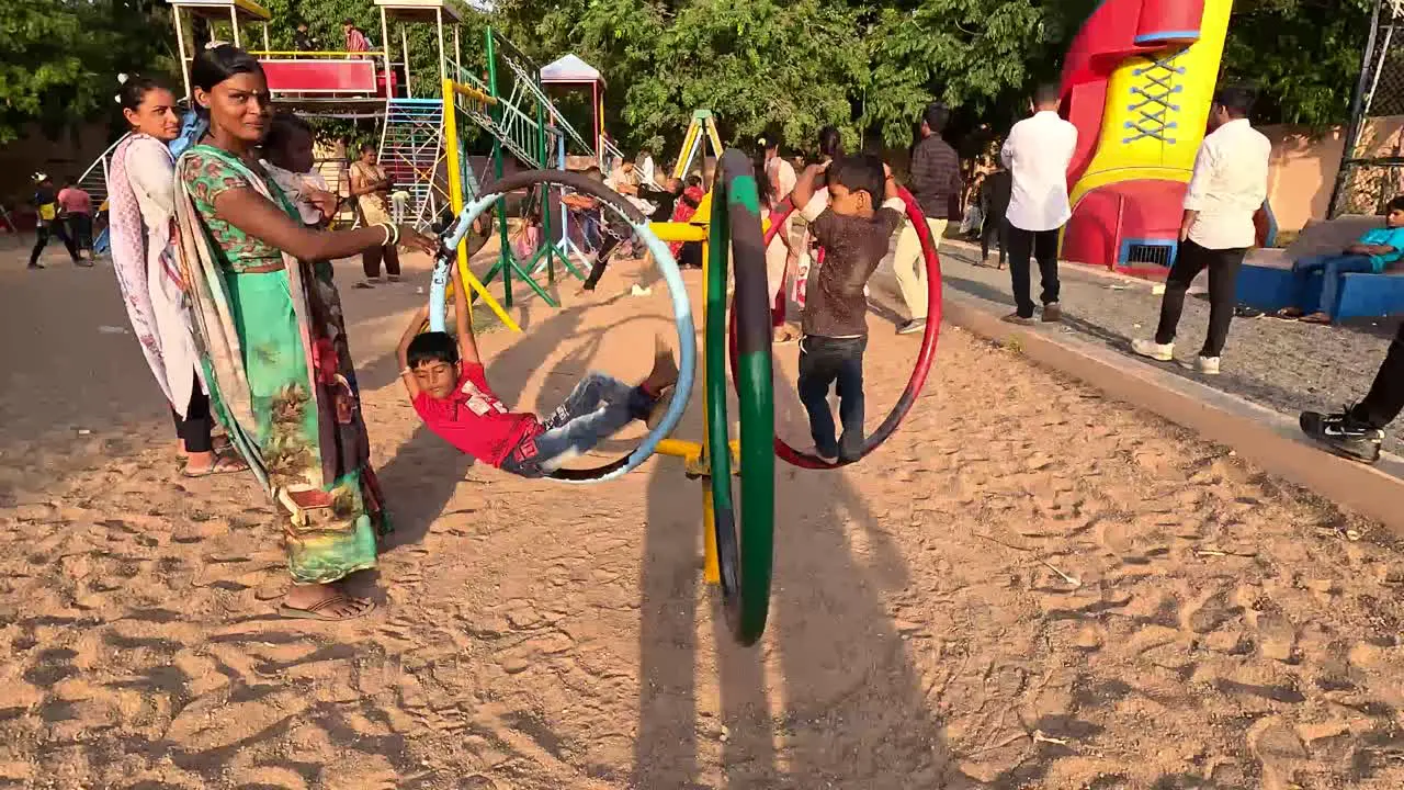 A woman takes her two children for a ride at an amusement park during vacation