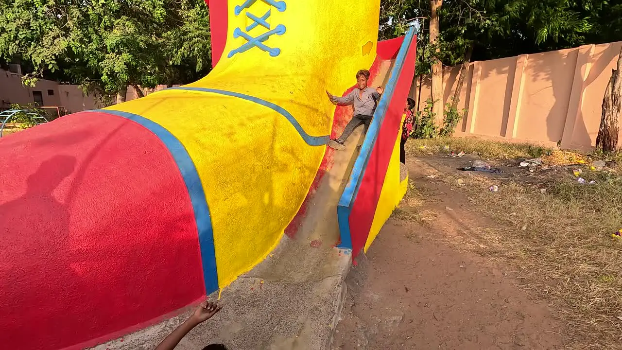 Small children are playing the game of sliding in a very big sliding ride