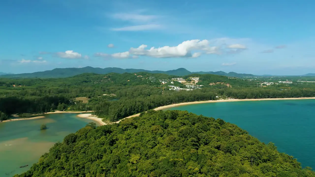 4K Cinematic nature aerial footage of a drone flying over the beautiful beach of Bang Tao in Phuket Thailand on a sunny day