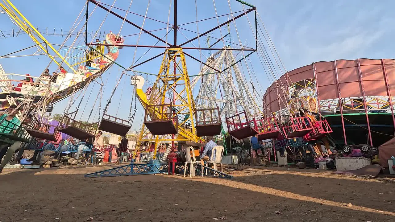 Young boys and girls are enjoying the rides in the amusement park