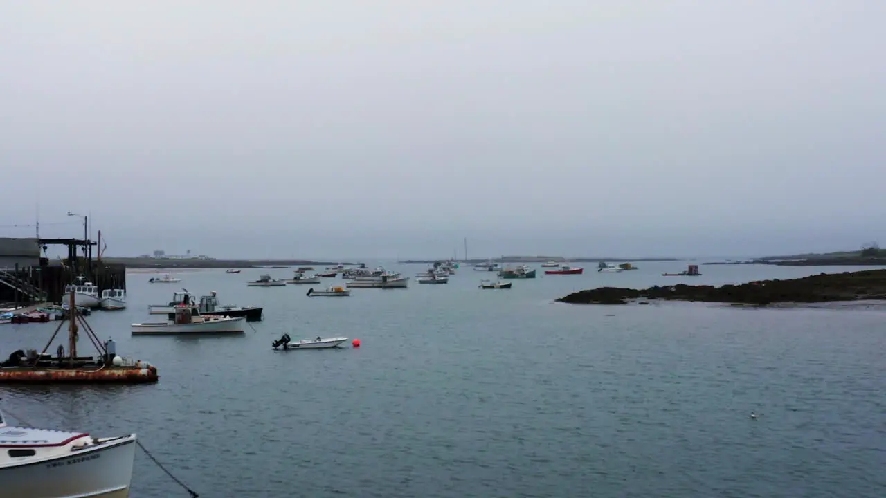 Zoom dolly Hitchcock effect over marina in Maine with fishing and lobster boats HD 30p