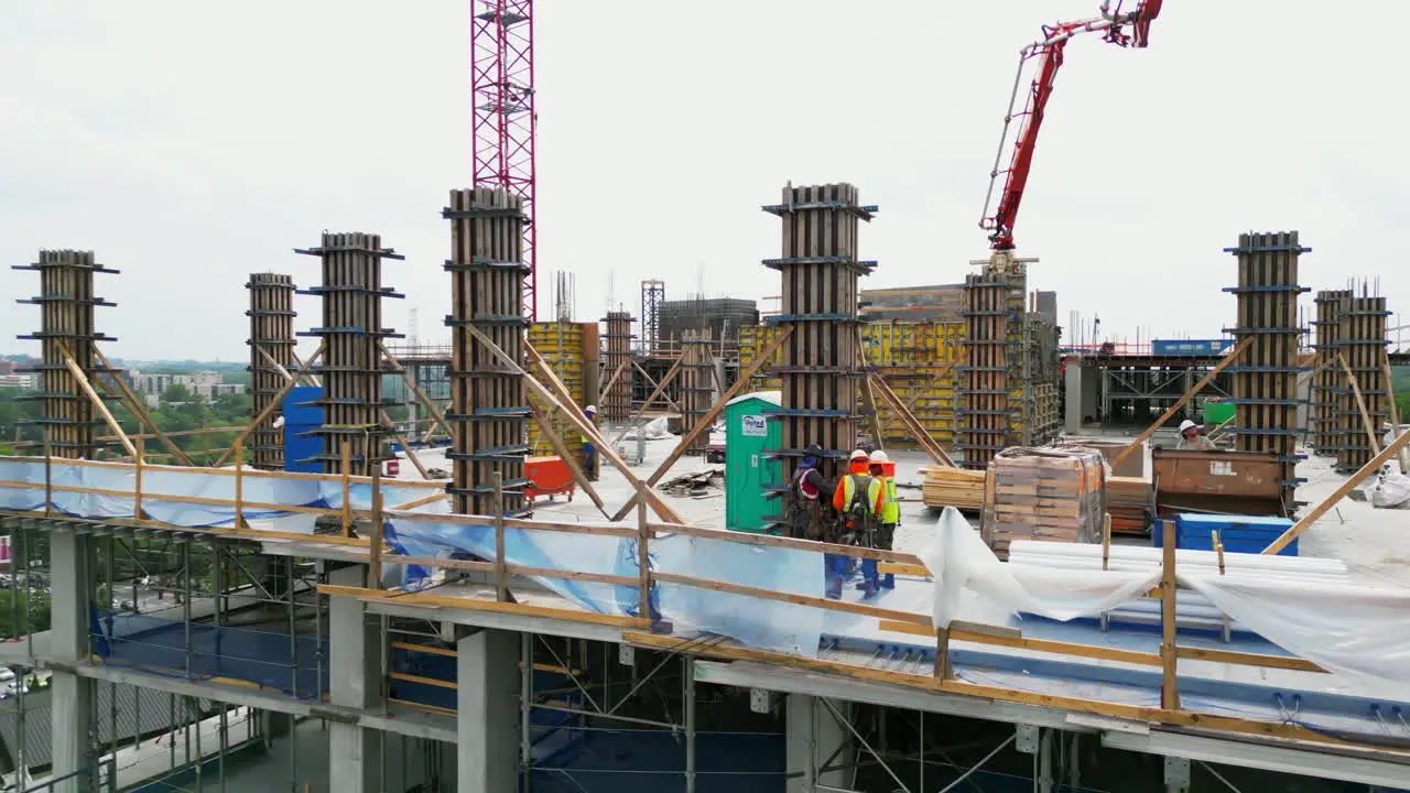 Aerial footage of works on construction site of modern tall buildings in city