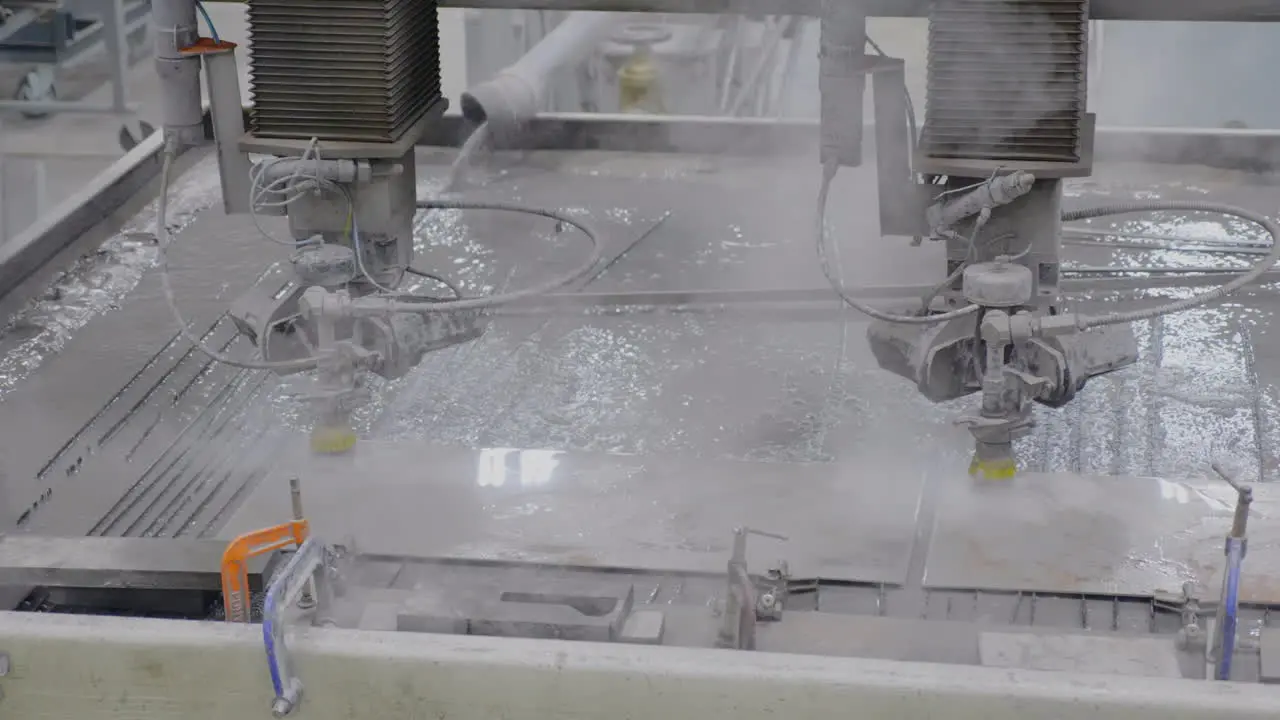 Dual Water jet cutting machines cutting steel with steam rising