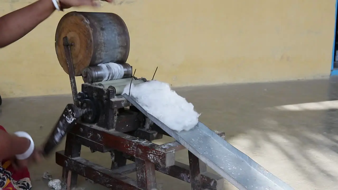 Rural poor Indian women spinning yarn at cottage industry to make cotton thread out of raw cotton small scale industry