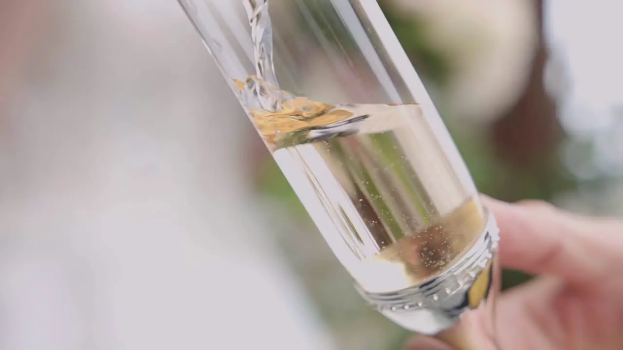 pouring champane into the glass close up shot celebration