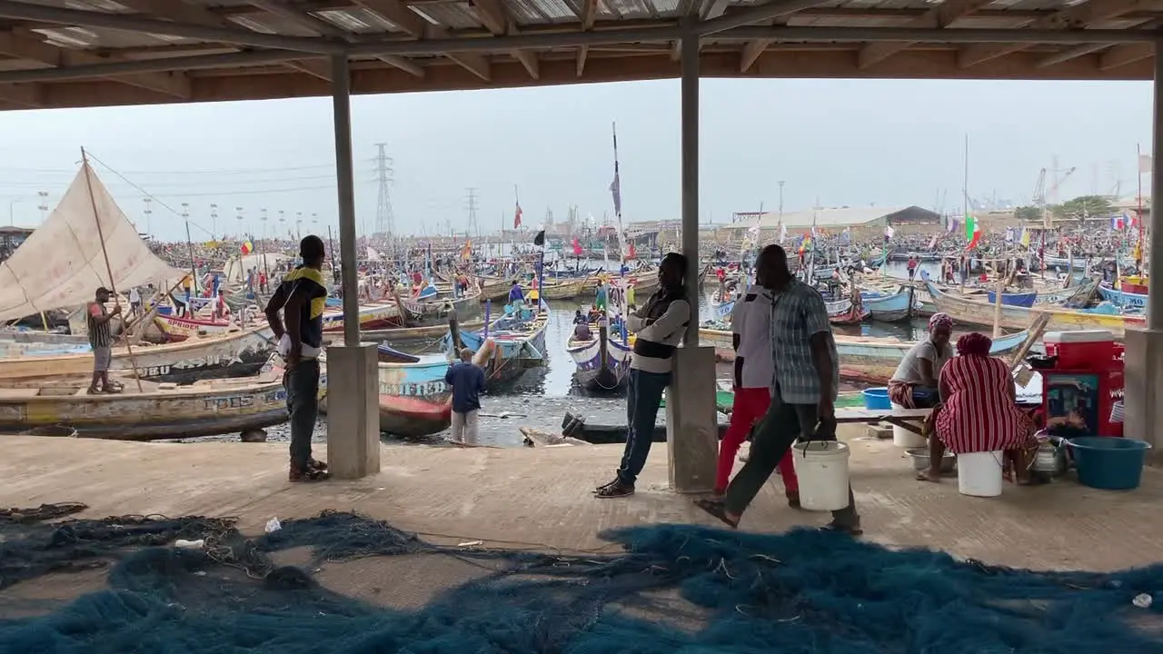 african fishermen on the quay of a seafood market